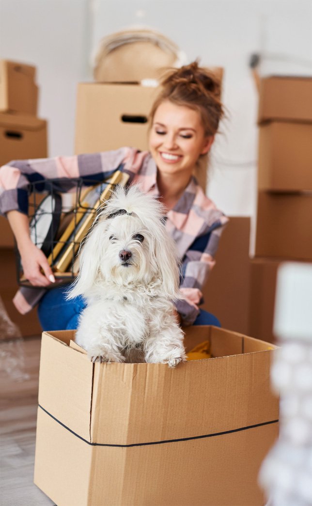 smiling self storage customer packing boxes